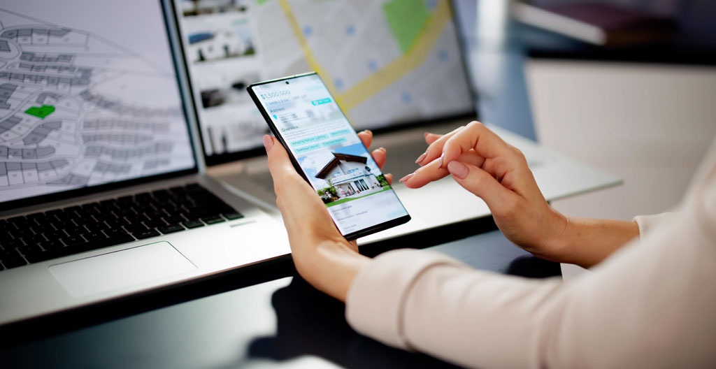 Héritière vérifiant des informations immobilières sur son téléphone dans un appartement